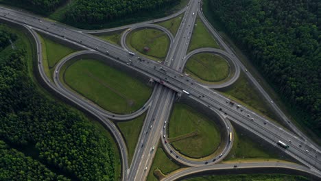 aerial. traffic interchange. top view of the road, city and forest. summer video from the drone.