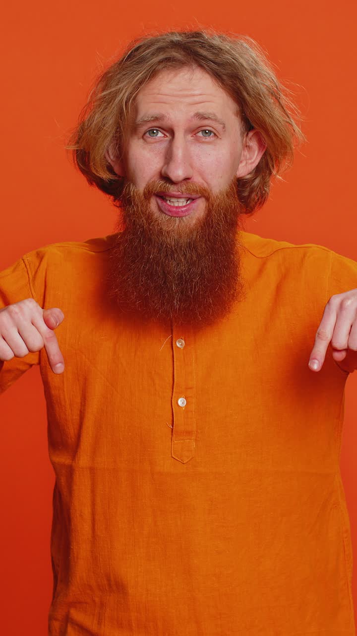 Caucasian man pointing down saying to subscribe gesturing ok like showing place for information