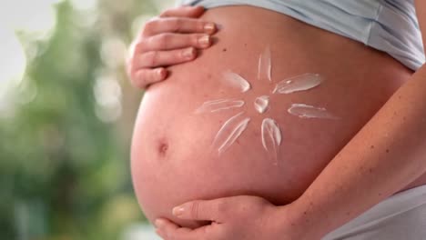 pregnant woman with lotion on belly