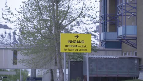 Walking-away-from-a-coronavirus-warning-near-a-hospital-in-Norway