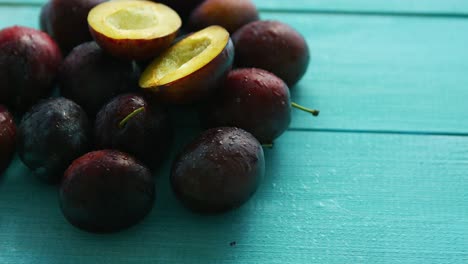 Purple-plums-on-blue-wood