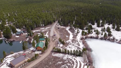 Drone-Aerial-of-the-winter-showing-the-vacation-homes-around-Island-Park-Reservoir-in-Island-Park-Idaho-parking-lot-and-gate