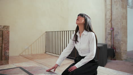 woman going down on her knees in the church to pray god