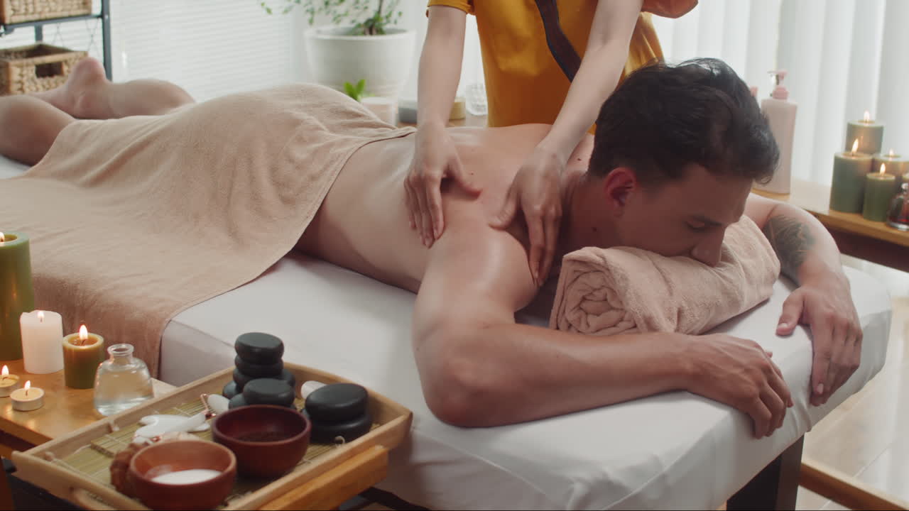 Man Relaxing on Couch during Massage at Spa Salon