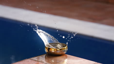 water splashing in a small bowel sending ripples outwards in a circular pattern