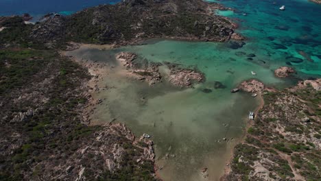 aerial video top view of particularly rocky geographical area on coast of sardinia in mediterranean sea during summer season