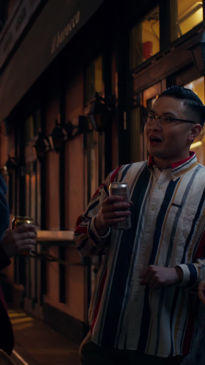 Friends enjoying drinks outdoors at night