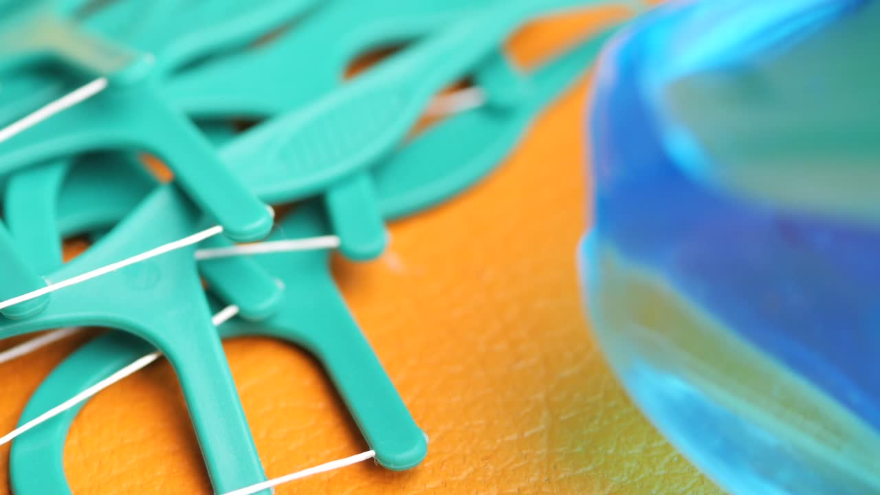 Close-up of teal-colored dental floss picks