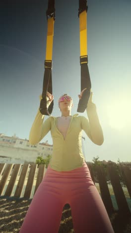 woman working out with suspension trainer