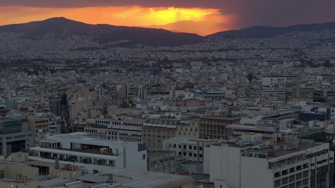 Reveal of a cloudy and colorful sunset over Athens, Greece