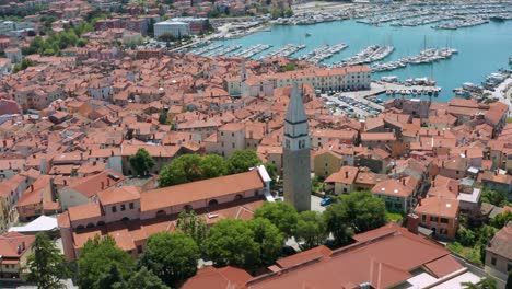 aerial shot flying over the city of izola, slovenia pulling away from the st