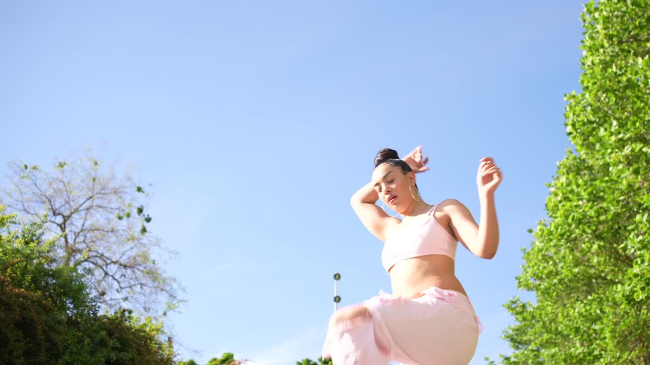 Woman Dancing Outdoors on a Sunny Day