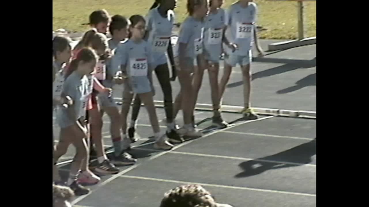 Kids lined up at race start under bright sun