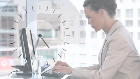 Animation-of-clock-moving-over-caucasian-businesswoman-using-computer