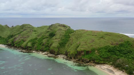 wide aerial of bukit merese hills and meadow on lombok island on cloudy day