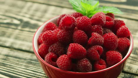 Bowl-of-raspberry-on-wooden-desk-