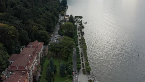 beautiful aerial of road and pier next to lake como, italy