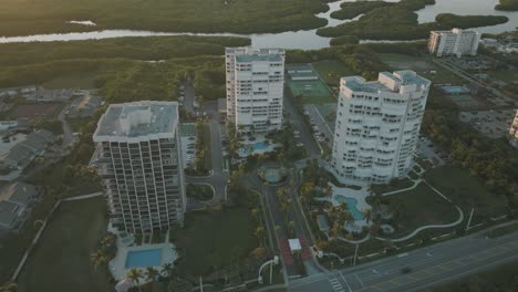 aerial video of high rise condominiums on the florida coast during sunset