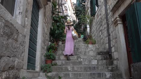 Beautiful-female-model-walking-up-the-old-towns-stairs-of-Dubrovnik