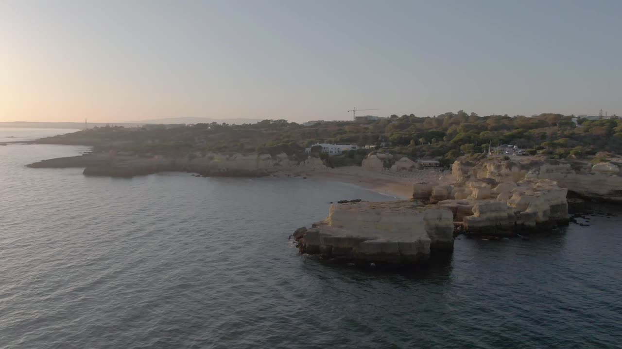 Aerial Sunset Drone Shoot of Coastline Above Water with Rock Formations