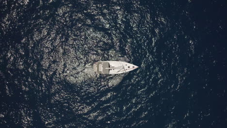 sailing alone in a deep and flat ocean on a summer day on a sailing yacht - rising up shot