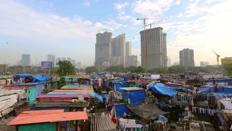 Dhobi-Ghat-(Mahalaxmi-Dhobi-Ghat)-was-an-open-air-laundromat-(lavoir)-in-Mumbai,-India.-The-washers,-known-as-dhobis,-work-in-the-open-to-clean-clothes-and-linens-from-Mumbai's-hotels-and-hospitals.