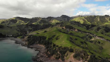 Aerial-view-of-beautiful-coastal-scenic-on-a-cloudy-day-in-Kereta,-Coromandel,-New-Zealand-pullback