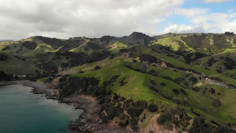 aerial view of beautiful coastal scenic on a cloudy day in kereta, coromandel, new zealand pullback