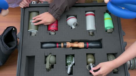 visitors, including school children, engage with dummy explosive weapon ammunition during a police training exercise