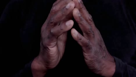 man praying to god with hands together caribbean man praying with black background stock footage-1