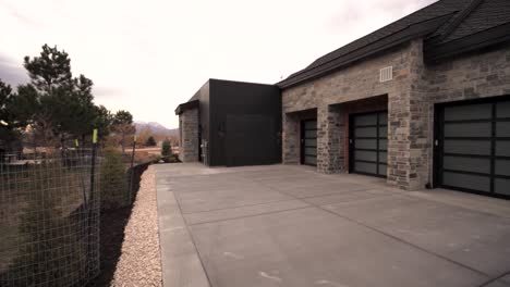 Driveway,-garages-and-panning-reveal-of-a-luxury,-custom-built-home