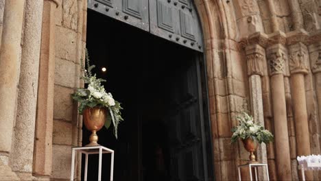 elegant white floral arrangement in gold vases at historic igreja matriz de barcelos entrance