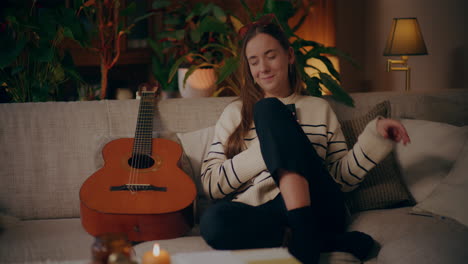 woman playing guitar writing song composing music