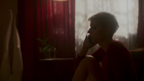 woman talking on phone in a room