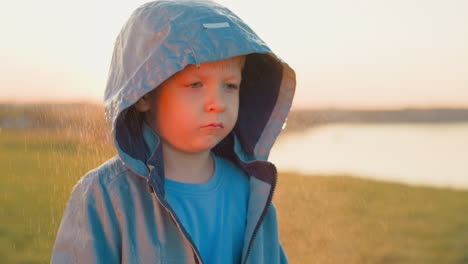 boy stands broken by harshness of reality small child finds solace in rhythm of rain serving as