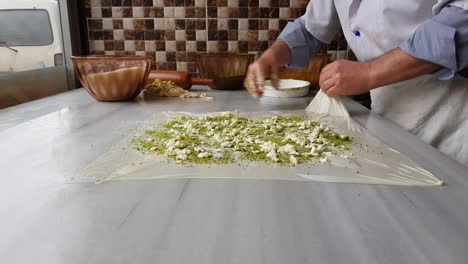 chef preparing famous turkish gaziantep dessert named katmer.