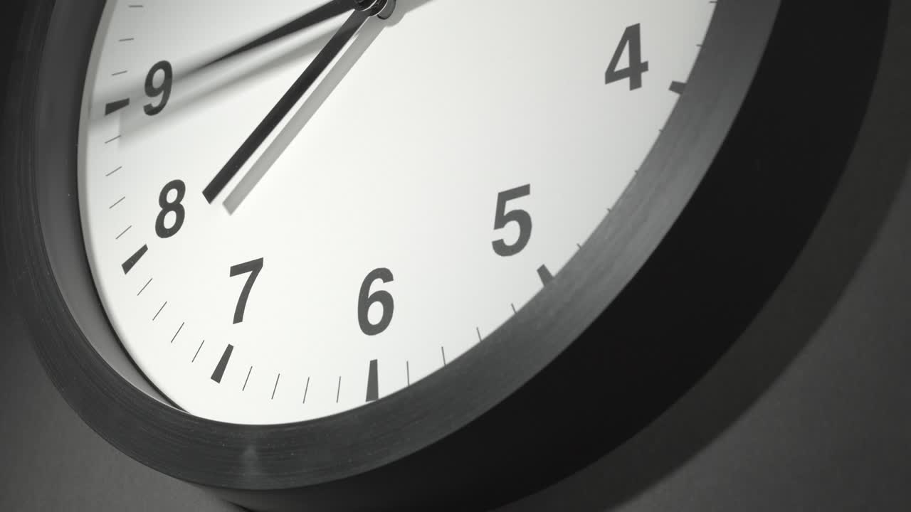 Clock Face in Time Lapse on Dark Grey Wall