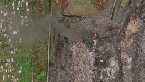 top down aerial footage of a fire burning in a landfill