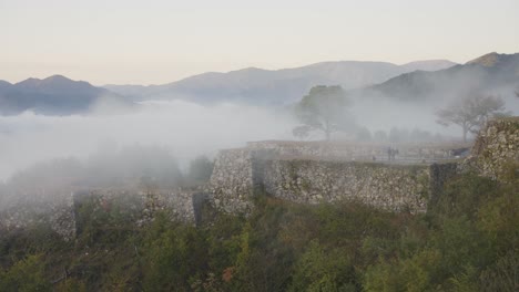 Mist-covering-Takeda-Castle-Ruins-at-Sunrise,-Hyogo-Japan