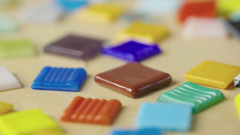 Colorful Mosaic Tiles on Wooden Surface