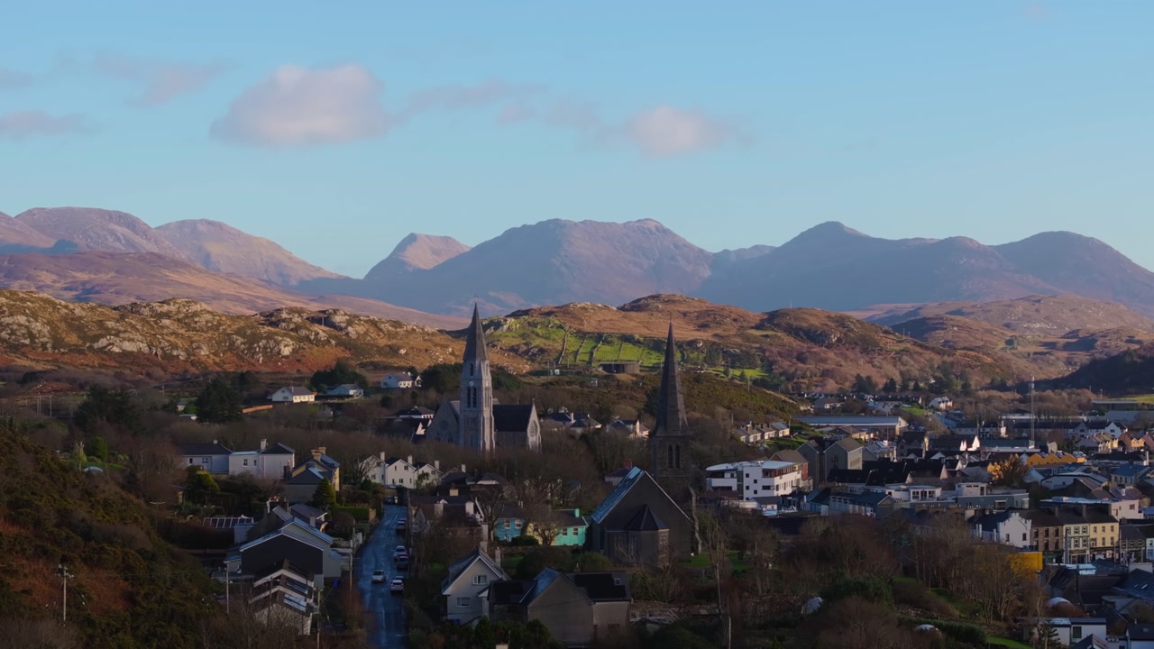 4K Aerial drone footage of St Joseph’s Church and Christ Church Clifden with Connemara Mountains Background_09