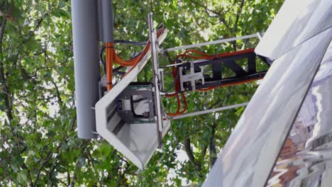 vertical shot of pantograph rising from the roof of the electric bus