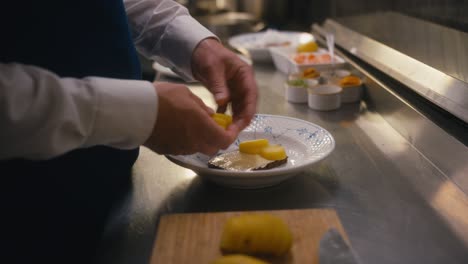 Slice-of-bread-with-potatoes-being-prepared-in-commercial-kitchen-by-chef