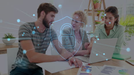 animation of illuminated padlock in shield over caucasian coworkers discussing reports on laptop