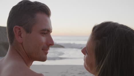 Young-adult-couple-relaxing-at-the-seaside