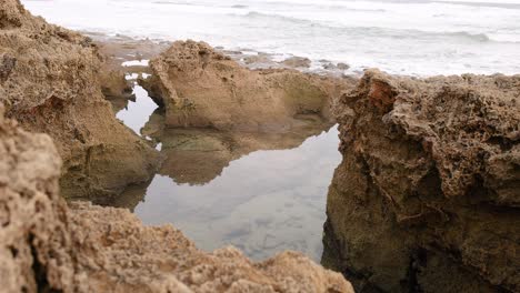 waves crashing over rocky coastal pools