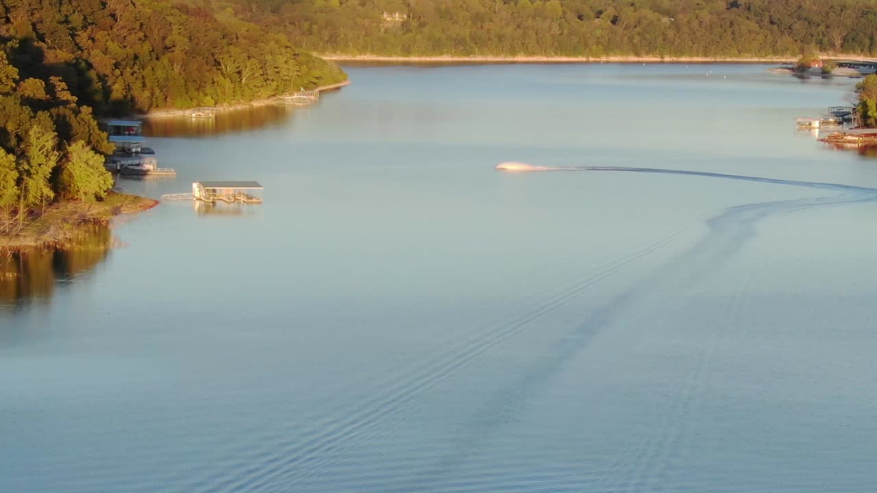 aerial view of jetski on the lake in the late evening