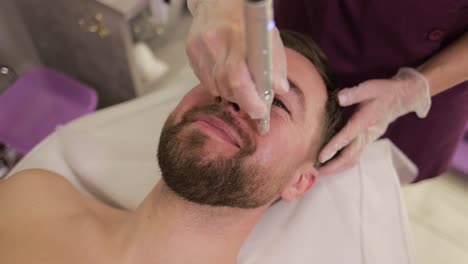 man receiving microdermabrasion facial treatment