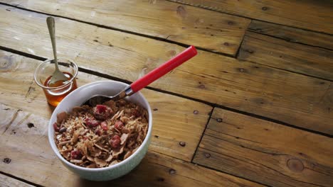 wheat flakes and honey on wooden table 4k