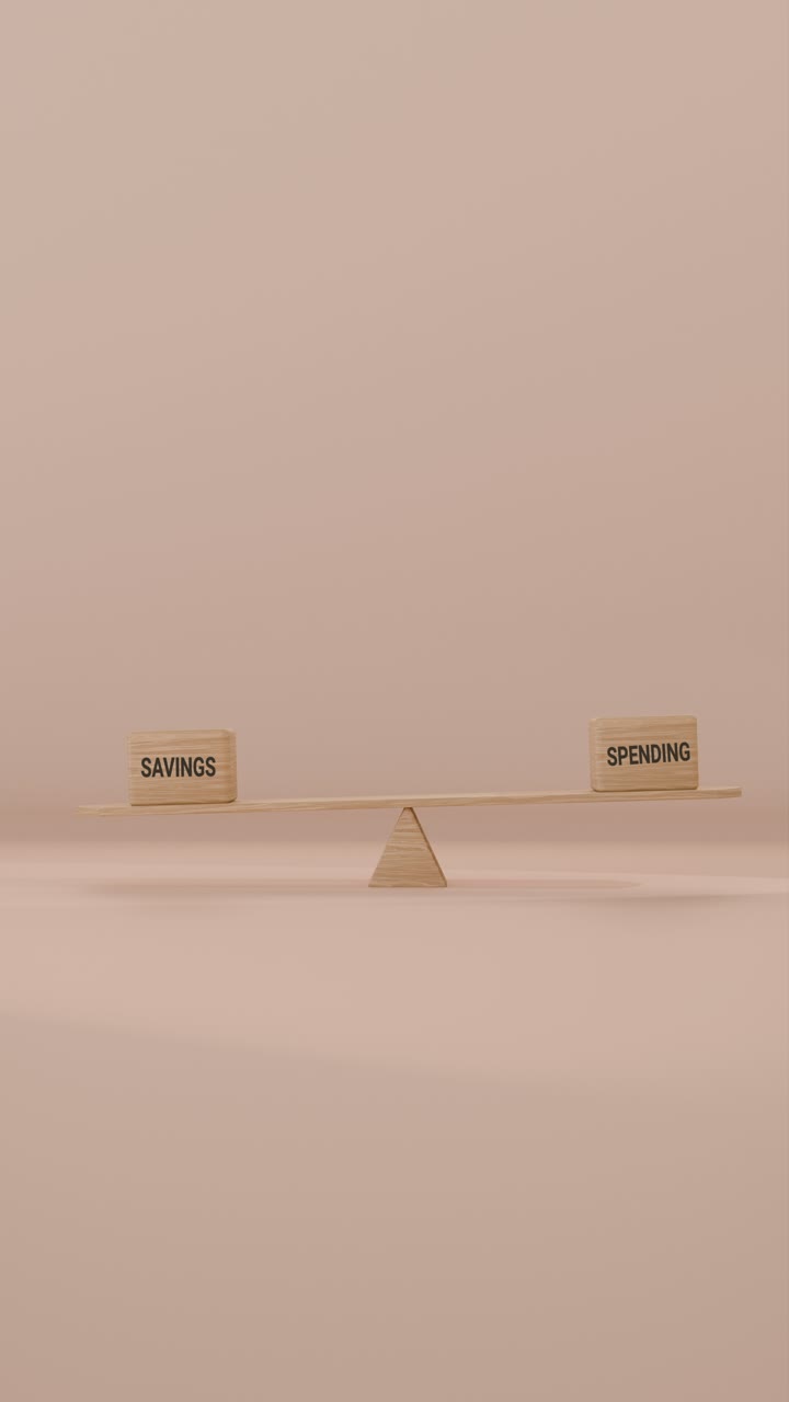 VERITCAL VIDEO OF SAVINGS AND SPENDING BALANCING ON SEESAW